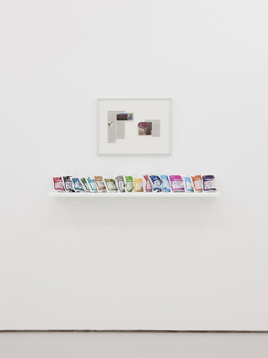 *Media Is A Plural Word*, 2018, inkjet on newsprint, McDonald's Happy Meal toys, MDF board, 41.5 x 55 x 2.5 cm