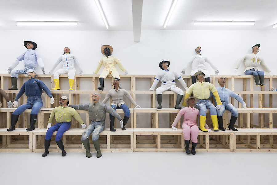 Oscar Murillo, *Human Resources*, 2016, Wooden seating, effigies, 8780 x 9830 cm