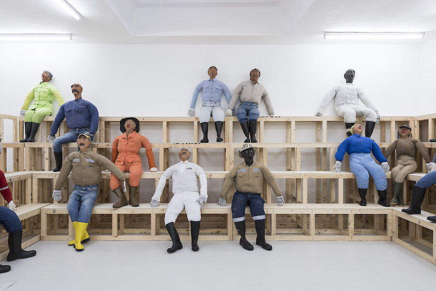 Oscar Murillo, *Human Resources*, 2016, Wooden seating, effigies, 8780 x 9830 cm