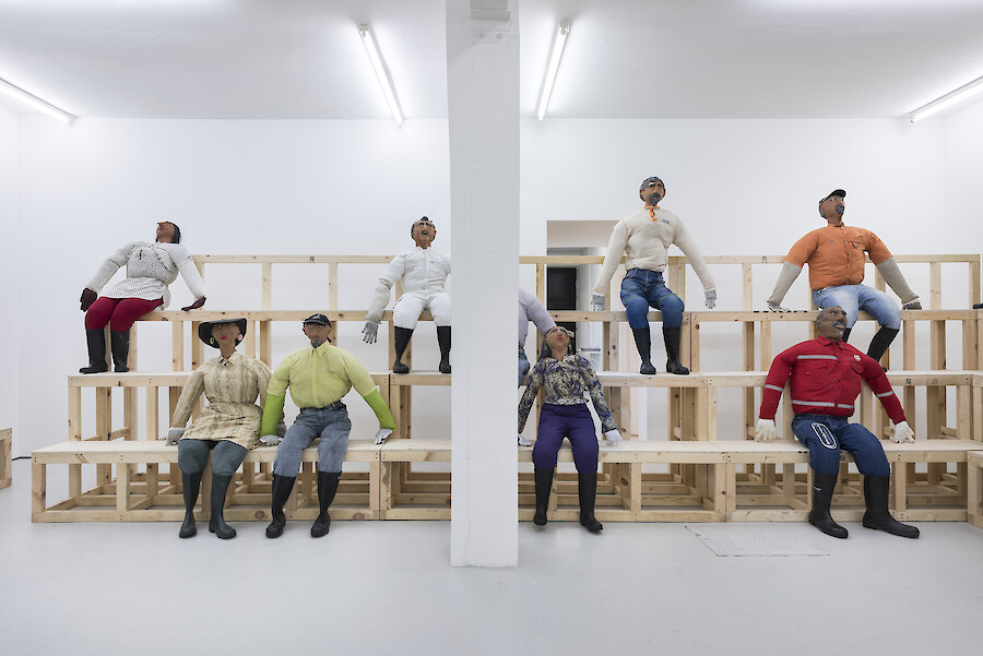 Oscar Murillo, *Human Resources*, 2016, Wooden seating, effigies, 8780 x 9830 cm
