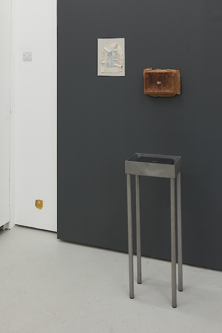 *Third Term*, 2016, Stainless steel vitrine table, Polymer clay, Newsprint, Card, Marker