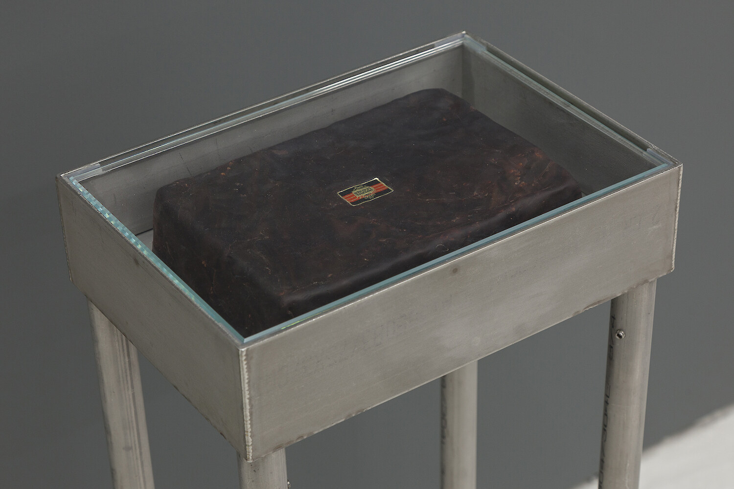 *Third Term* (detail view), 2016, Stainless steel vitrine table, Polymer clay, Newsprint, Card, Marker