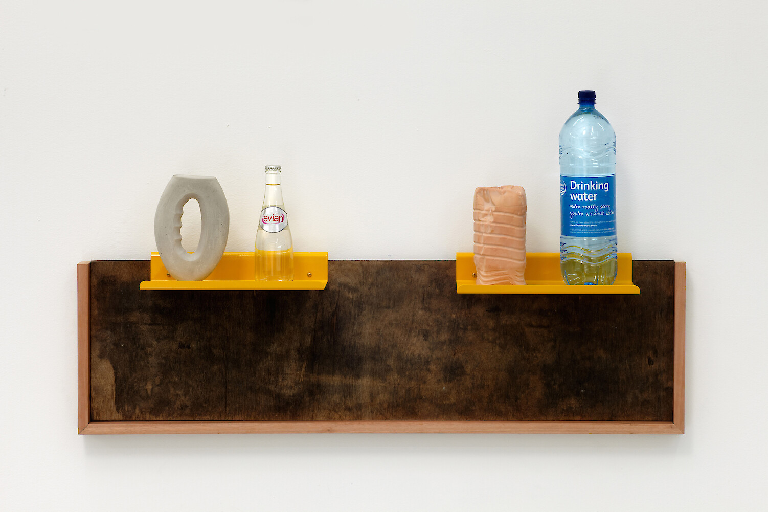 *Upcycle (Relief I)*, 2013, Fired wood, steel, Thames Water bottle, Evian Mineral water bottle, plaster, concrete, miranti, 61 x 106 x 21 cm