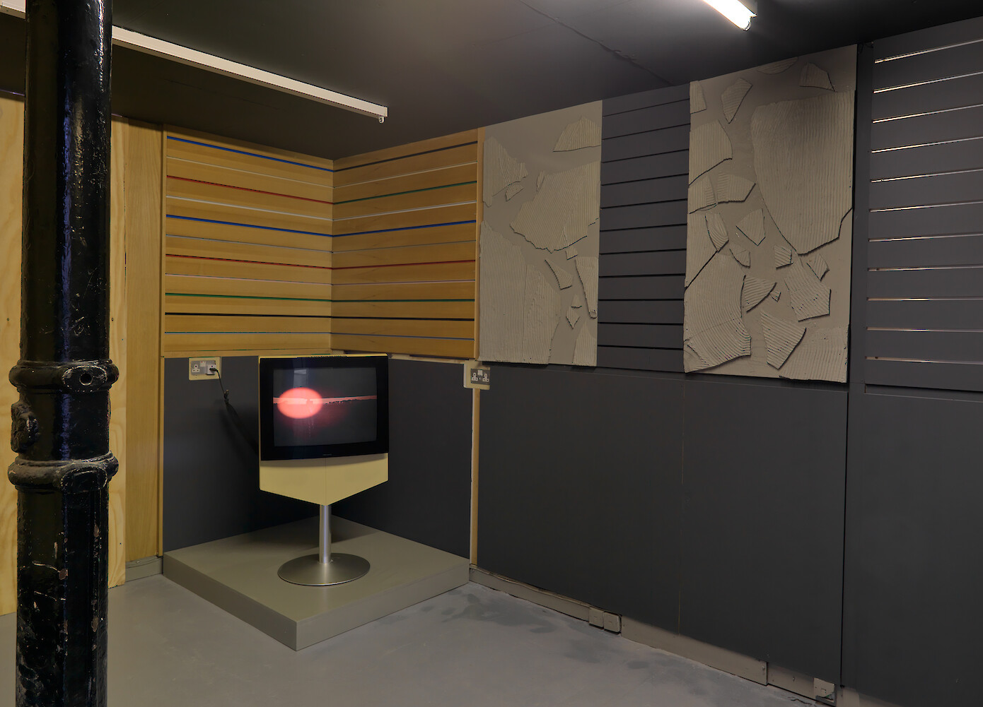 Lloyd Corporation, *Interior Music*, 2011, Beovision 1 television, video (10:53mins), pine boarding, concrete, aluminium treadplate, fire extinguisher, MDF