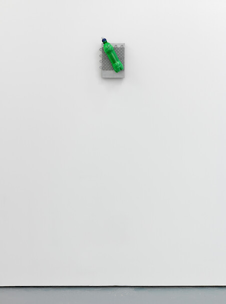 Lloyd Corporation, *Janus (Unexpected Twist)*, 2011, Miranti, aluminium, plastic flooring unit, soft drink bottle, concrete, squeeze bottle top, 28 x 15 cm