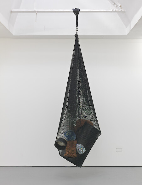 Lloyd Corporation, *Strata of Accumulation*, 2011, Polypropylene cargo net, plastic beer line cleaning bottle, plaster, woodstain, 1 gallon spring water bottle, hessian sandbags, terracotta dye, steel drum, swivel hook, soft drink bottle, concrete, squeeze bottle top, 350 x 115 x 80 cm