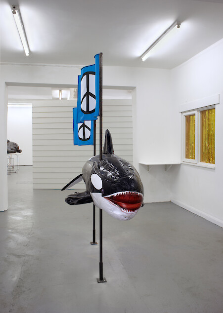 Ed Fornieles, *ORCA*, 2011, Inflatable whale, steel, nylon peace flags, expanding foam, 219 x 230 x 77 cm