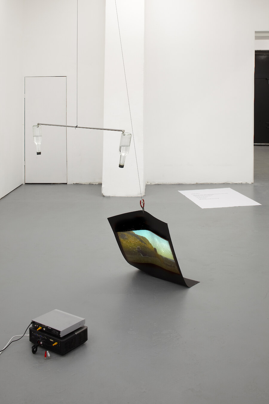 Chooc Ly Tan, *Us, The Stars That Flash in Rhythm... and Everything Else We Aren't Aware Of*, 2012, Inverted bottled water, magnets, steel, paper, concrete, video projector